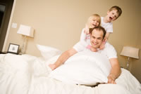 Family Enjoying Their Bed